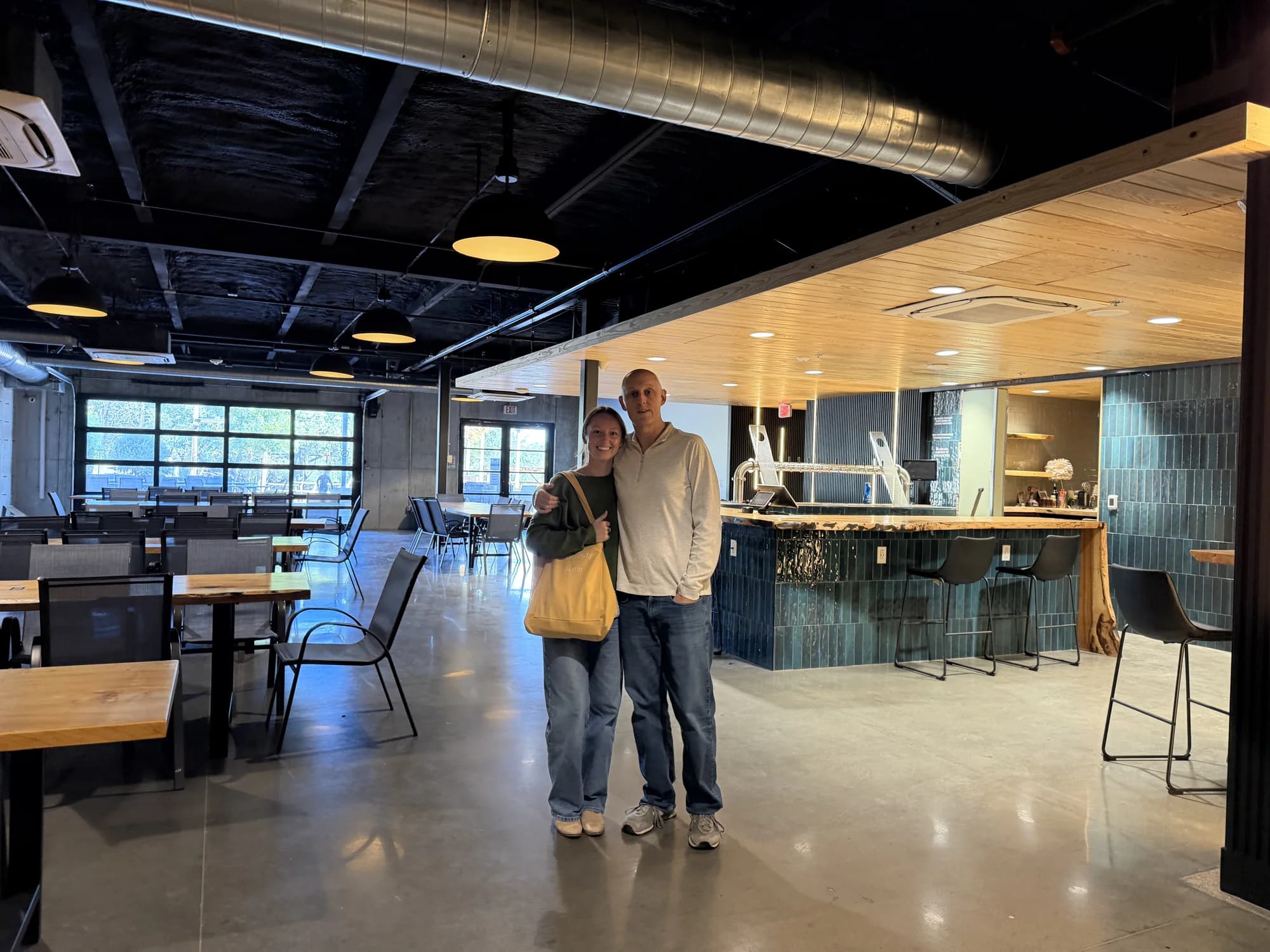 An early visit to the downstairs space at Fast Friends, with people, shared tables and warm wood